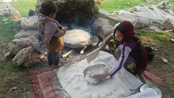 Bakhtiari girl baking bread