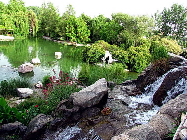 A beautiful artificial lake and waterfall in Isfahan Flowers Garden