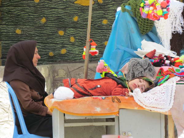 A disabled woman knitting in Rudkhan Castle (Qaleh Rudkhan) Local Market