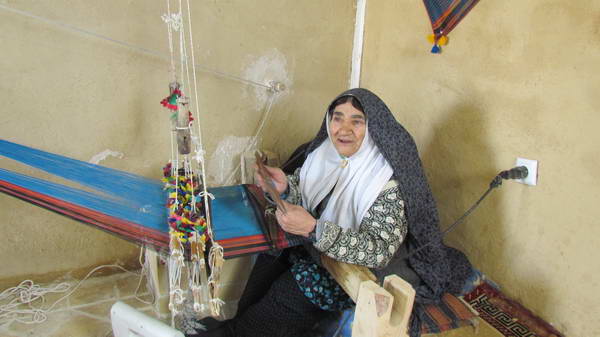 Haj Sekinen, an old woman of Varzaneh, Weaving a napkin