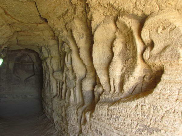 Carvings on the sandy walls of Khorbas cave
