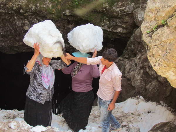 Nomads carrying Snow pieces from Ice cave in Dorfak peak